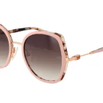Pink-framed sunglasses with tortoiseshell accents and gradient lenses, metal nose bridge, and slim pink temples