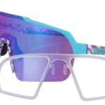 Oversized white-framed sunglasses with purple-blue mirrored lenses and a turquoise accent.