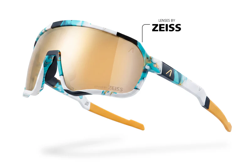 Ski goggles with a turquoise patterned frame and gold mirrored lenses, labeled 'Lenses by ZEISS'