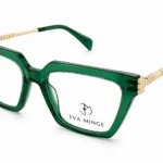 Green transparent eyeglasses with rectangular frames and gold-tone temples, Eva Minge branding on the lens area.