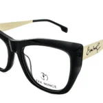 Black oversized plastic eyeglasses with beige arms and Eva Minge signature on the temples.