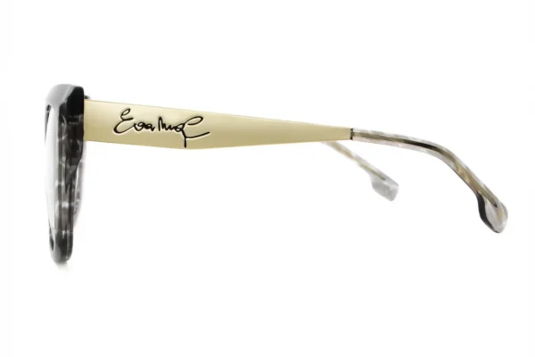 Side view of sunglasses with a beige temple bearing a black handwritten signature.