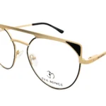 Gold metal eyeglasses with round lenses, clear nose pads, black temple tips, Eva Minge branding on the temples