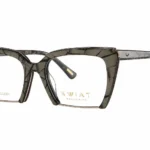 Oversized square eyeglasses with a dark marbled frame and gold branding on the lens (KWAT Exclusive).